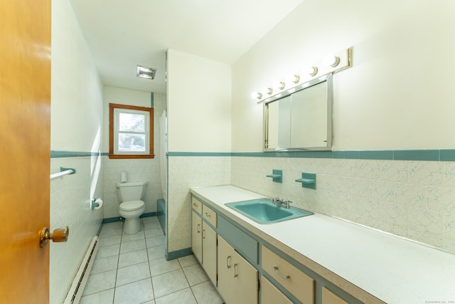 bathroom with a wainscoted wall, toilet, tile patterned flooring, a baseboard radiator, and vanity