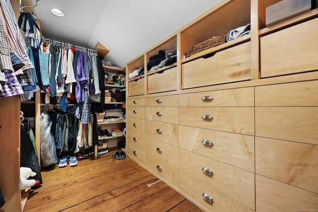 walk in closet featuring vaulted ceiling and wood finished floors