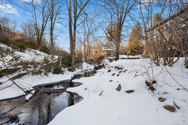 snowy yard with a garage