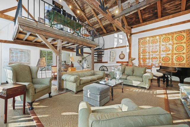 interior space with a towering ceiling, wood ceiling, wood finished floors, stairs, and beam ceiling