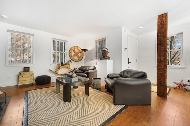 living area with hardwood / wood-style flooring, baseboards, and recessed lighting