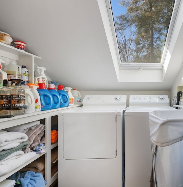 laundry room featuring laundry area, a skylight, and washer and dryer