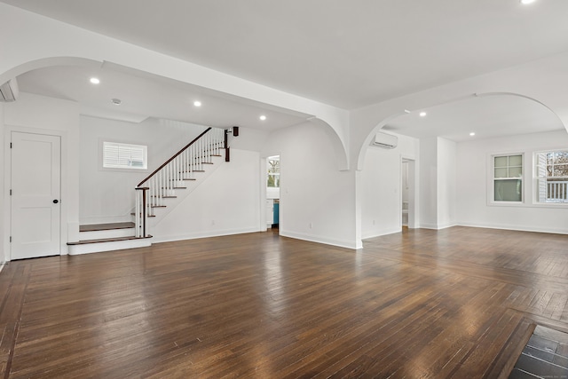 unfurnished living room featuring stairs, wood finished floors, and recessed lighting