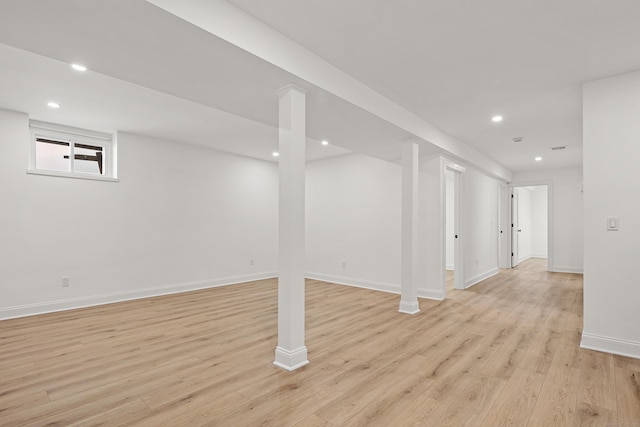 below grade area with recessed lighting, baseboards, and light wood finished floors