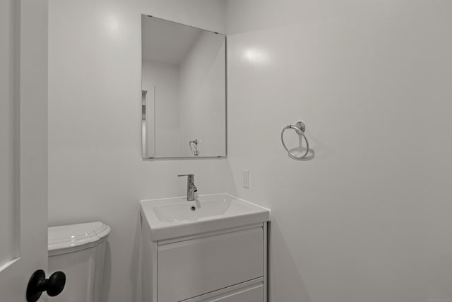 bathroom featuring toilet and vanity