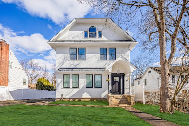 view of front of property featuring a shingled roof, a front yard, fence, and stucco siding