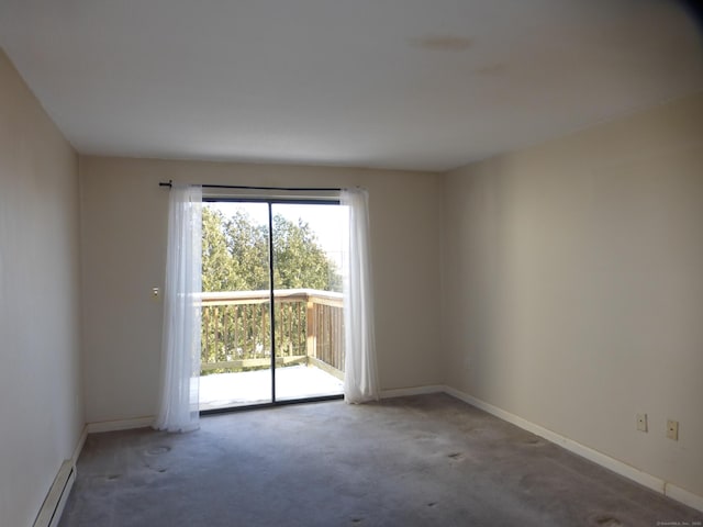 empty room with carpet floors and a baseboard heating unit