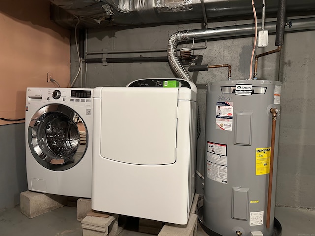 laundry area featuring laundry area, electric water heater, and washer and clothes dryer