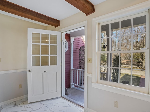 entryway with beamed ceiling, baseboards, and marble finish floor