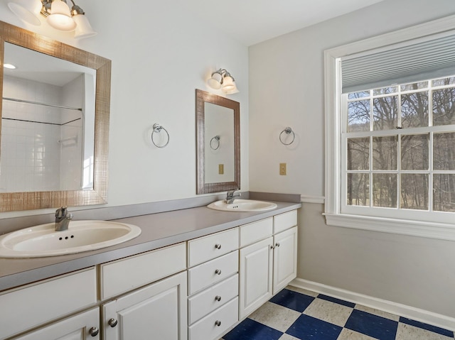 full bathroom featuring tile patterned floors, a sink, and plenty of natural light
