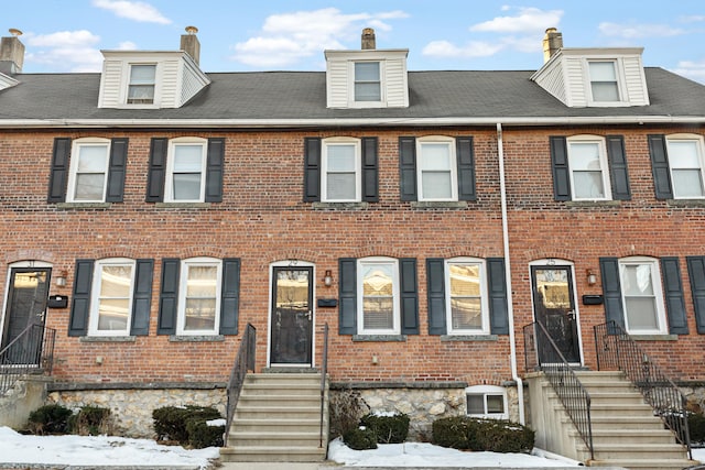 view of property featuring entry steps and brick siding