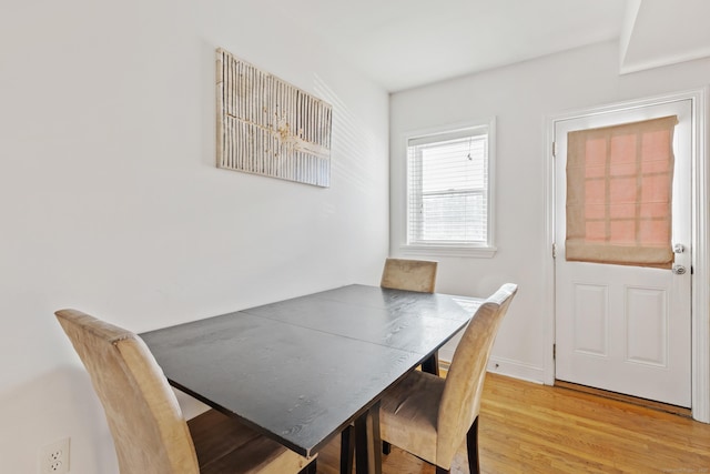 dining area featuring baseboards and wood finished floors