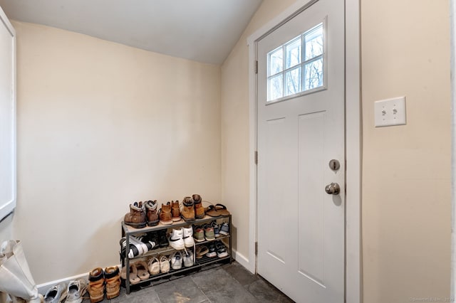 doorway to outside with baseboards