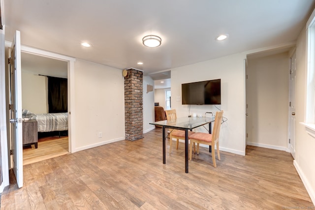 office with baseboards, light wood finished floors, recessed lighting, and ornate columns