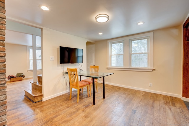 dining room with baseboards, wood finished floors, and recessed lighting