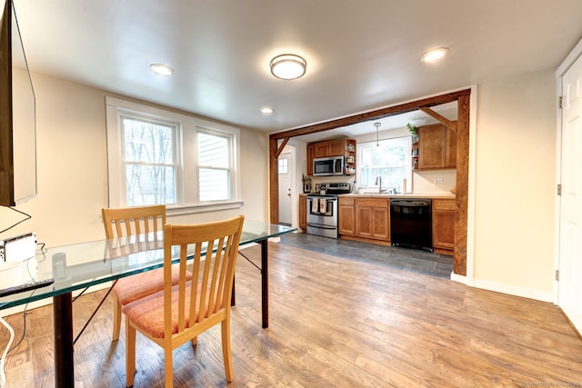 dining area with baseboards, light wood-type flooring, and recessed lighting