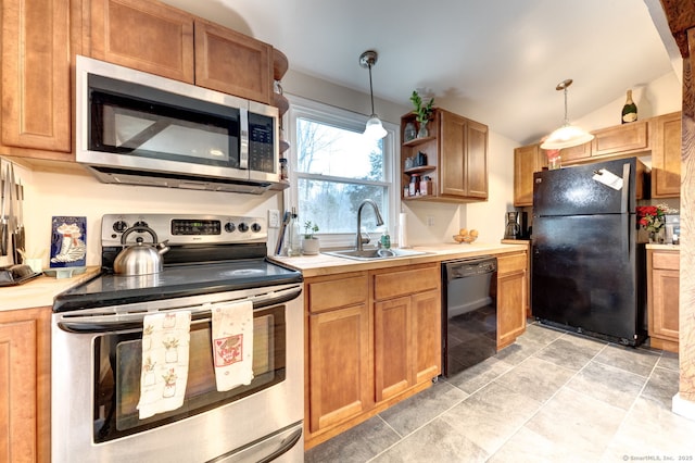 kitchen featuring vaulted ceiling, light countertops, a sink, and black appliances