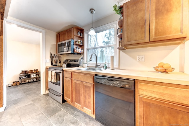 kitchen with stainless steel appliances, light countertops, a sink, and open shelves