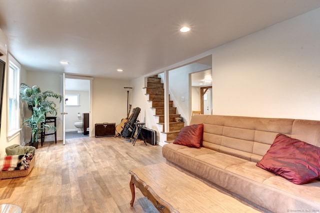 living area with light wood-type flooring, recessed lighting, and stairs