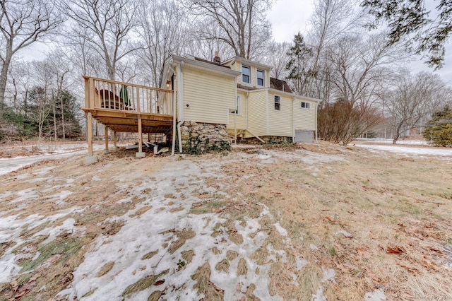 view of home's exterior featuring a deck and a chimney