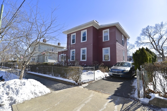 view of front of house with aphalt driveway and a fenced front yard