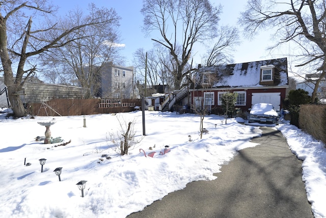 snowy yard with a garage