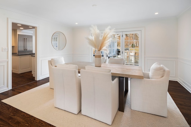 dining space featuring dark wood finished floors, crown molding, and recessed lighting