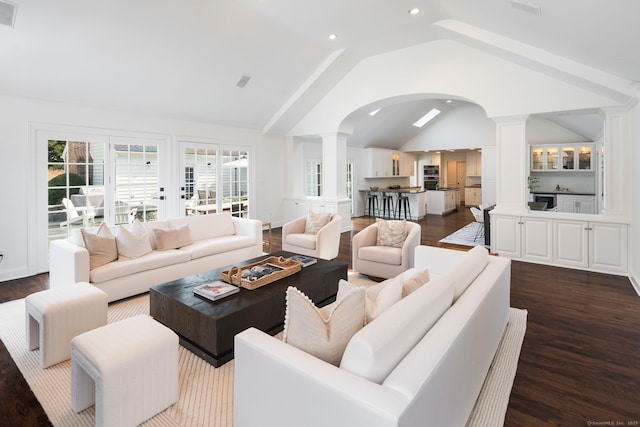 living room featuring ornate columns, visible vents, dark wood-type flooring, and recessed lighting