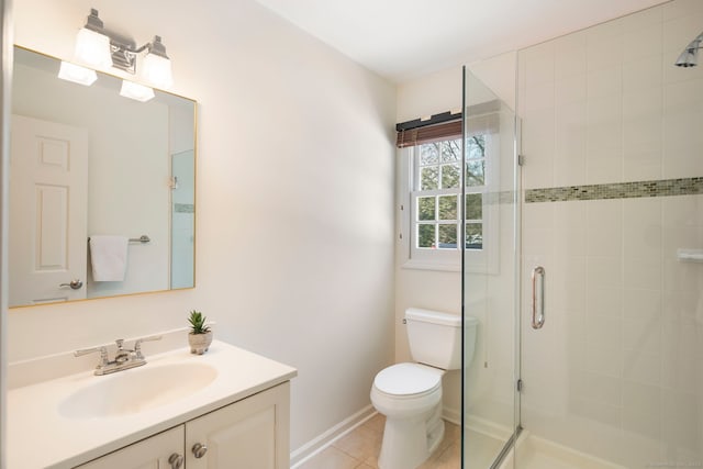 full bath featuring toilet, vanity, baseboards, a shower stall, and tile patterned floors