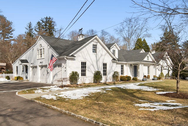 view of front of home featuring an attached garage, fence, driveway, roof with shingles, and a front yard