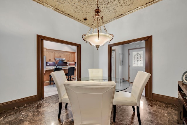 dining space featuring marble finish floor and baseboards