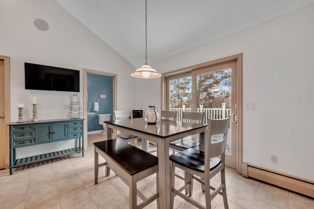 dining room with light tile patterned floors, baseboards, a baseboard heating unit, and vaulted ceiling