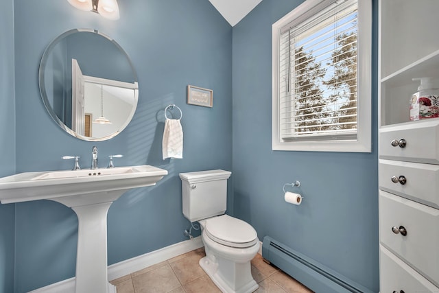 bathroom featuring a baseboard radiator, tile patterned flooring, toilet, and baseboards