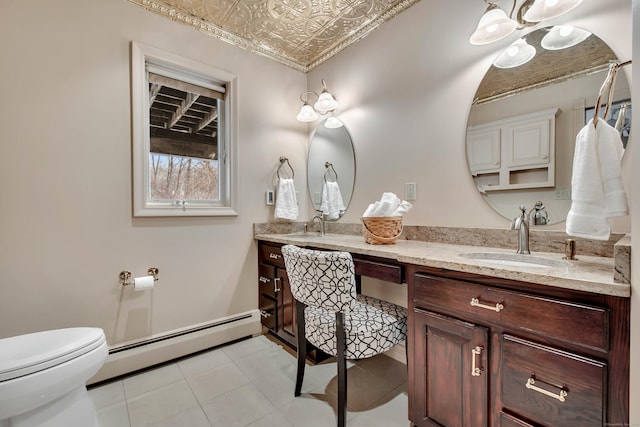 bathroom featuring an ornate ceiling, double vanity, toilet, a baseboard heating unit, and a sink