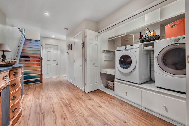 clothes washing area featuring recessed lighting, laundry area, separate washer and dryer, baseboards, and light wood-type flooring