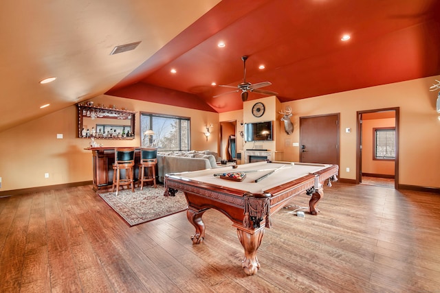 playroom with a bar, light wood-style flooring, billiards, and vaulted ceiling