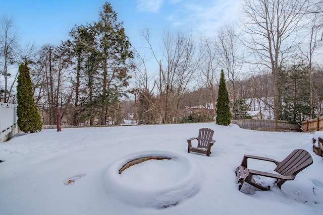 snowy yard with fence