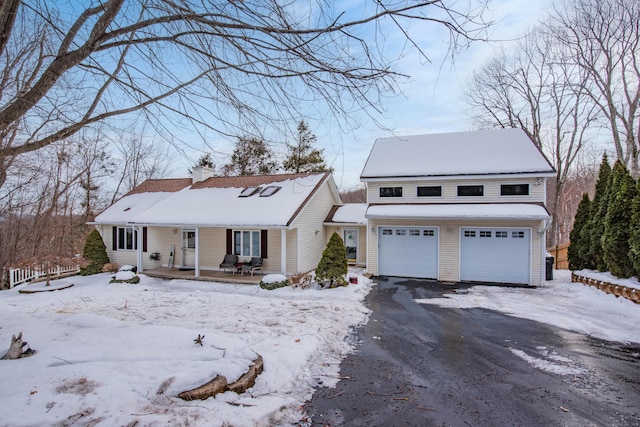 view of front of home with an attached garage, driveway, and a chimney