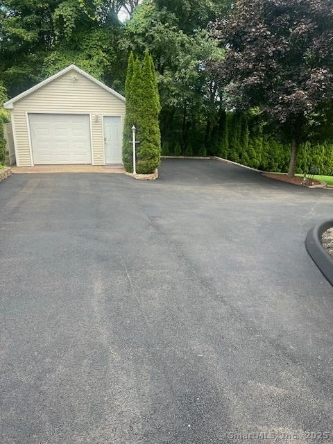 detached garage featuring aphalt driveway