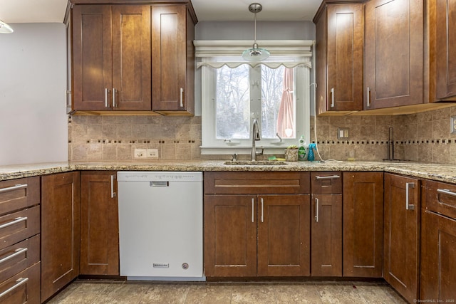 kitchen featuring sink, pendant lighting, dishwasher, light stone countertops, and tasteful backsplash