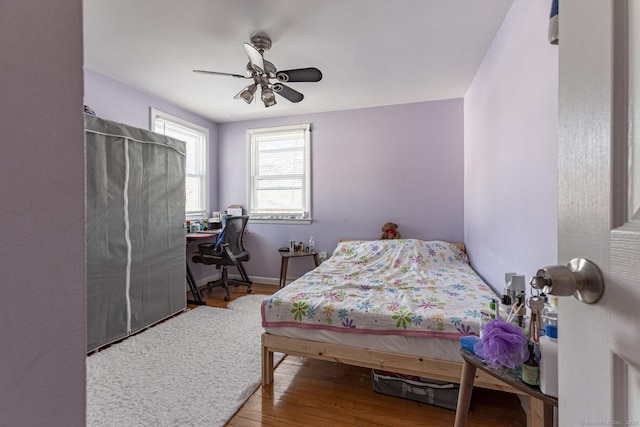 bedroom with hardwood / wood-style flooring and ceiling fan