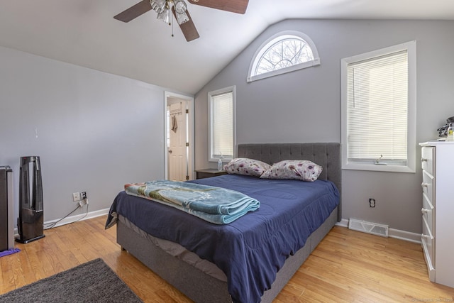 bedroom with ceiling fan, lofted ceiling, and light hardwood / wood-style floors