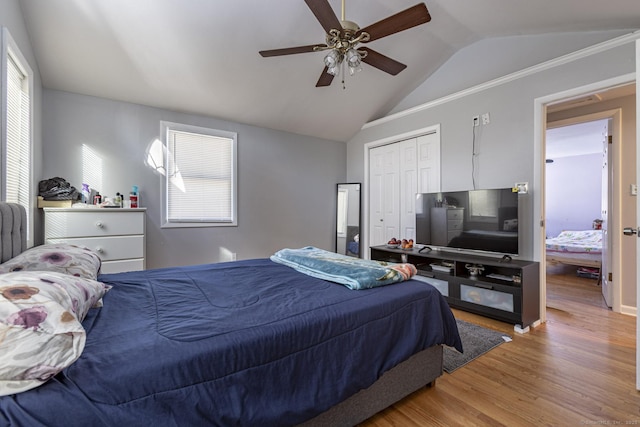 bedroom featuring hardwood / wood-style flooring, ceiling fan, vaulted ceiling, and a closet