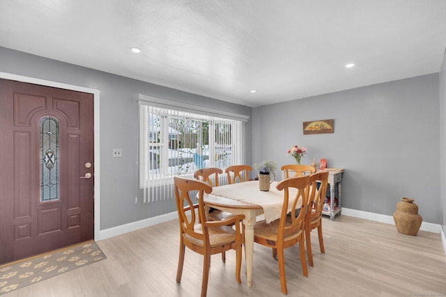 dining area with light wood-type flooring, baseboards, and recessed lighting