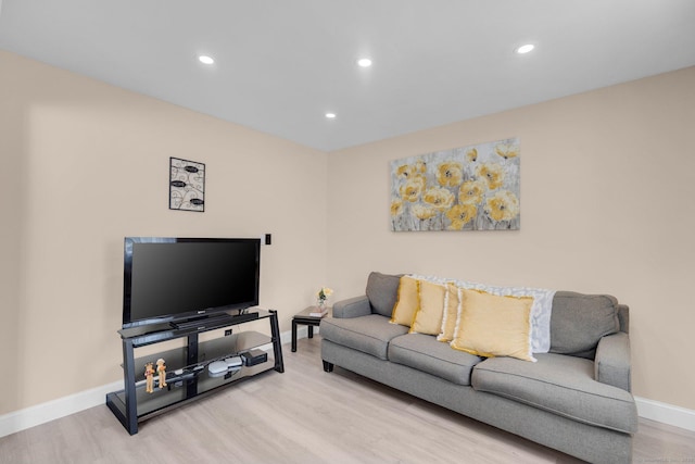 living room with recessed lighting, baseboards, and wood finished floors