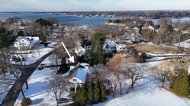 snowy aerial view featuring a water view