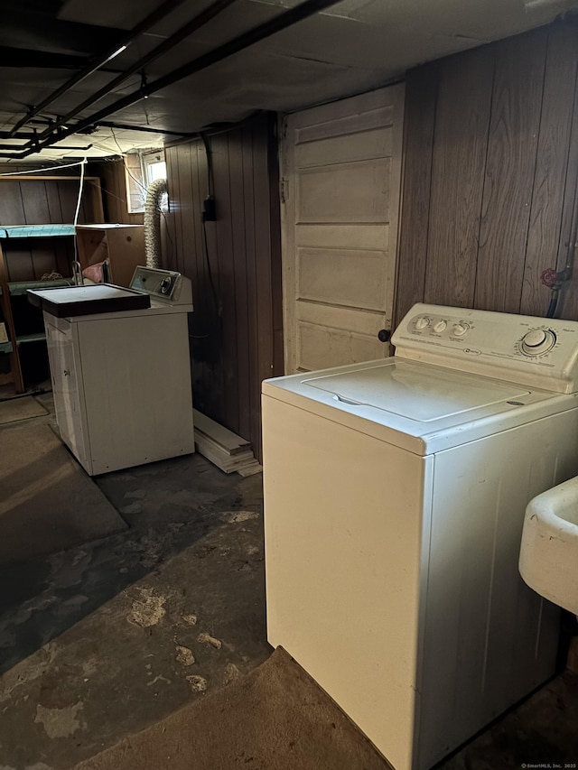 washroom featuring laundry area, wood walls, and washer / clothes dryer