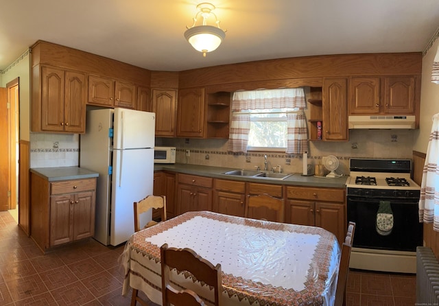 kitchen featuring a sink, backsplash, under cabinet range hood, white appliances, and open shelves