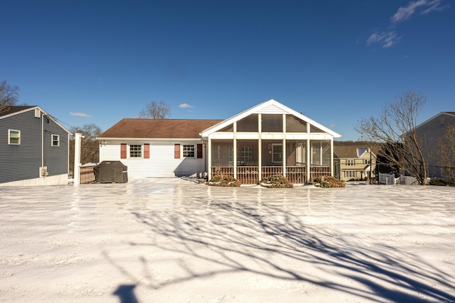 back of house featuring a sunroom and a jacuzzi