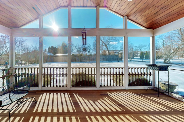 unfurnished sunroom with lofted ceiling, plenty of natural light, and wooden ceiling